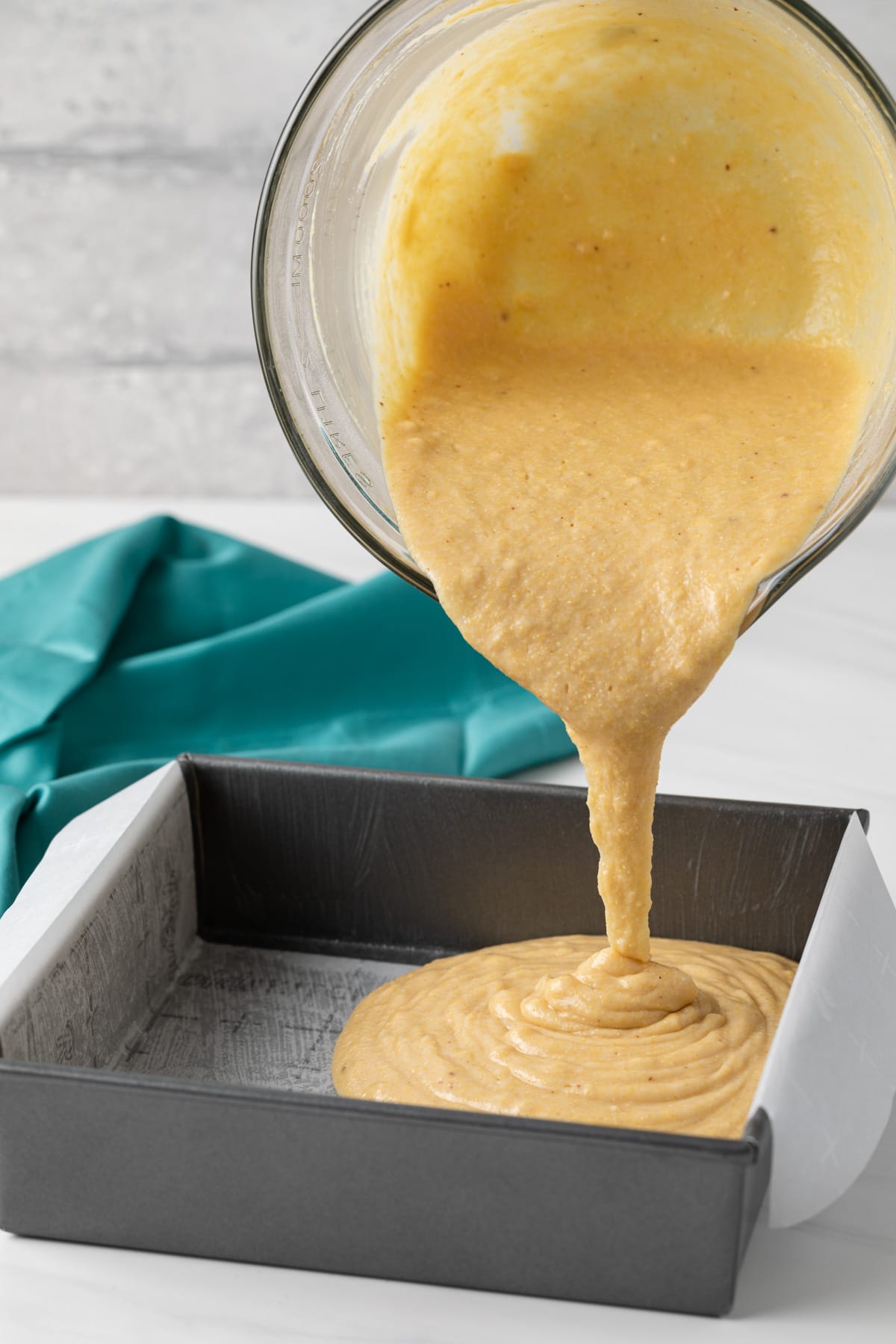 cornbread batter being poured into a pan