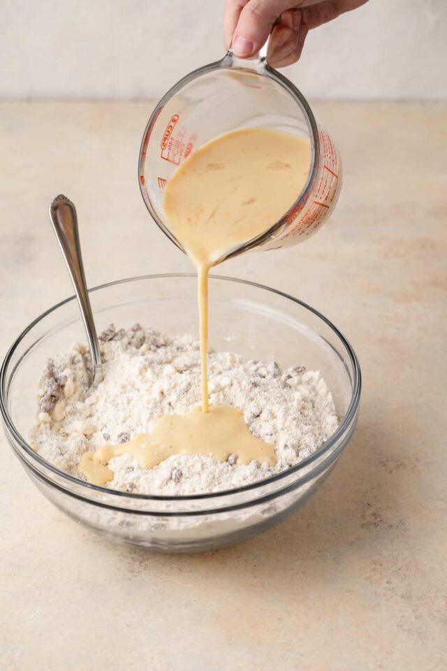 Buttermilk being poured into dough