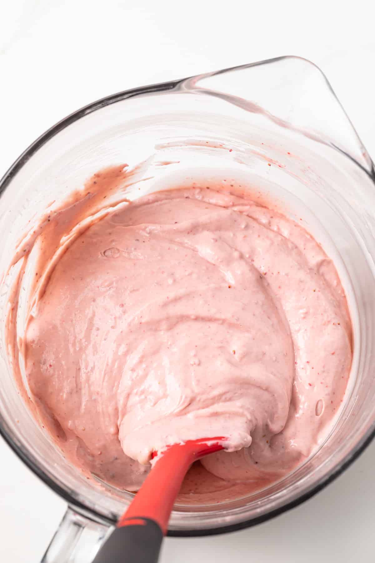 Strawberry cheesecake filling in glass bowl.