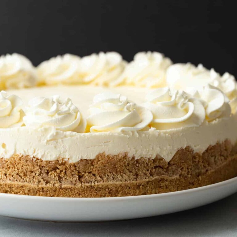 side view of no bake cheesecake on a white serving plate