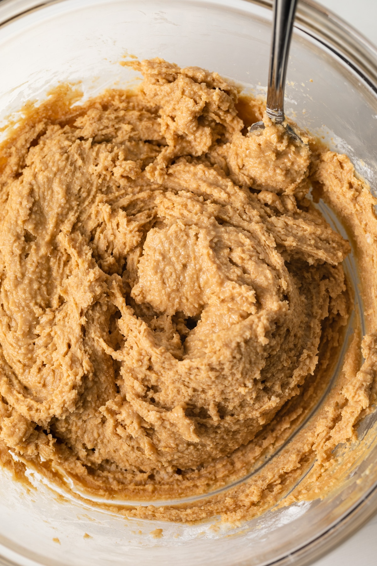 Peanut butter bar dough in glass bowl.