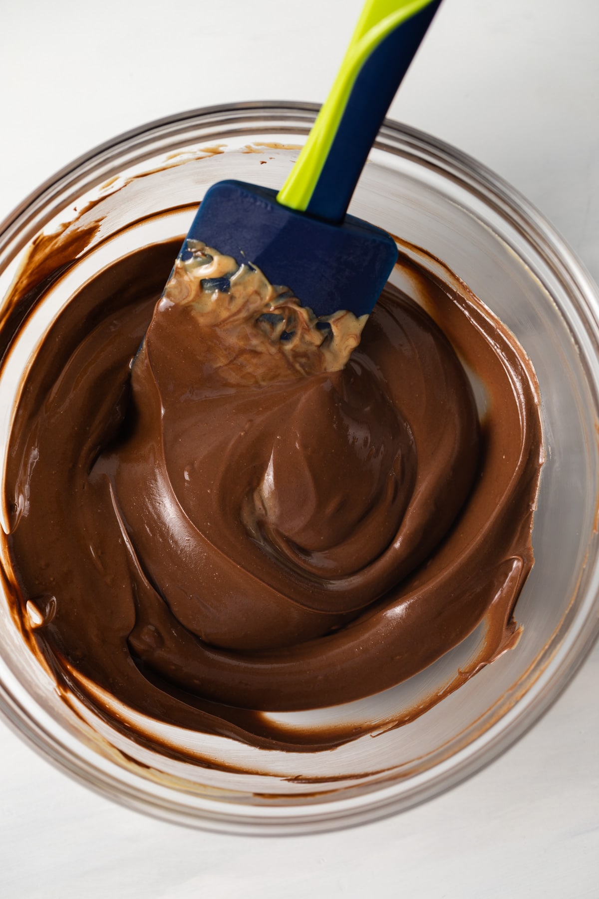 Melted chocolate in glass bowl.