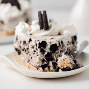 Slice of no bake Oreo cheesecake with bite taken out.