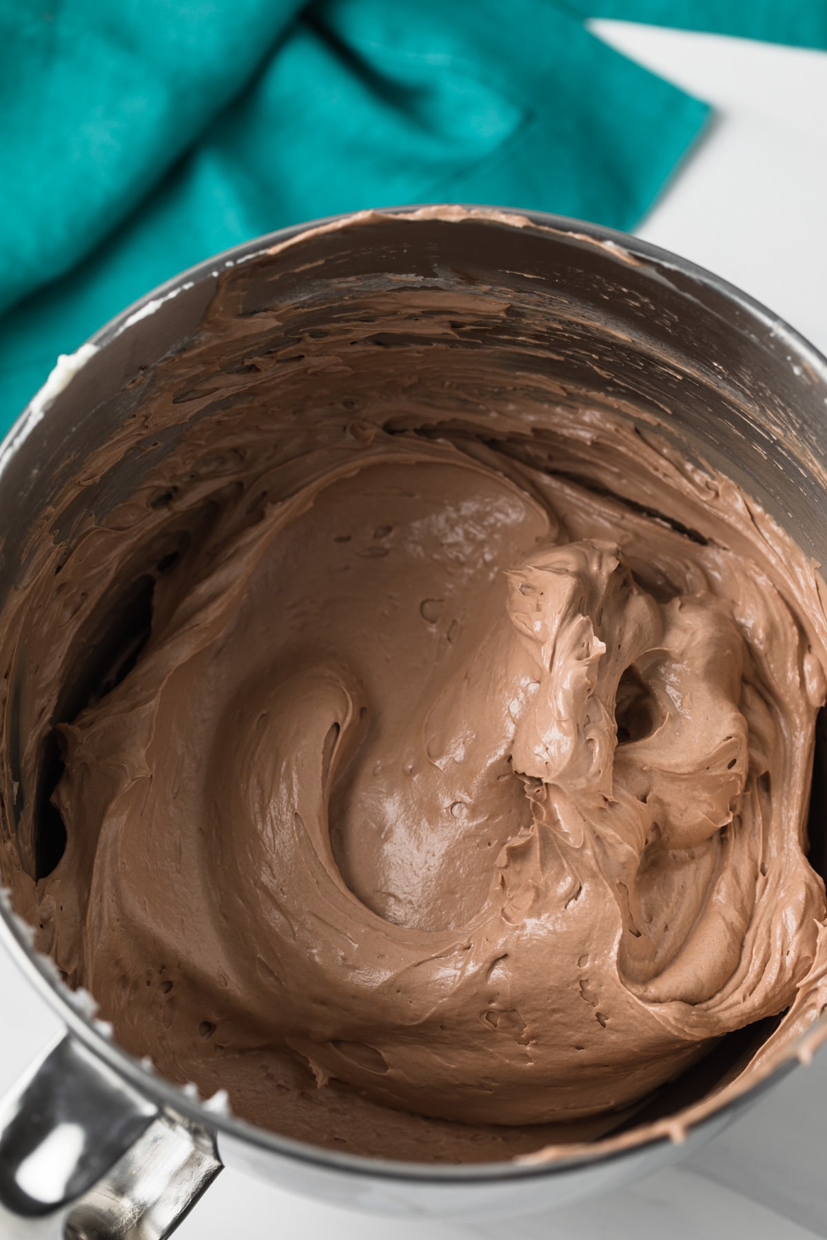 Nutella swiss meringue buttercream in stainless steel mixing bowl