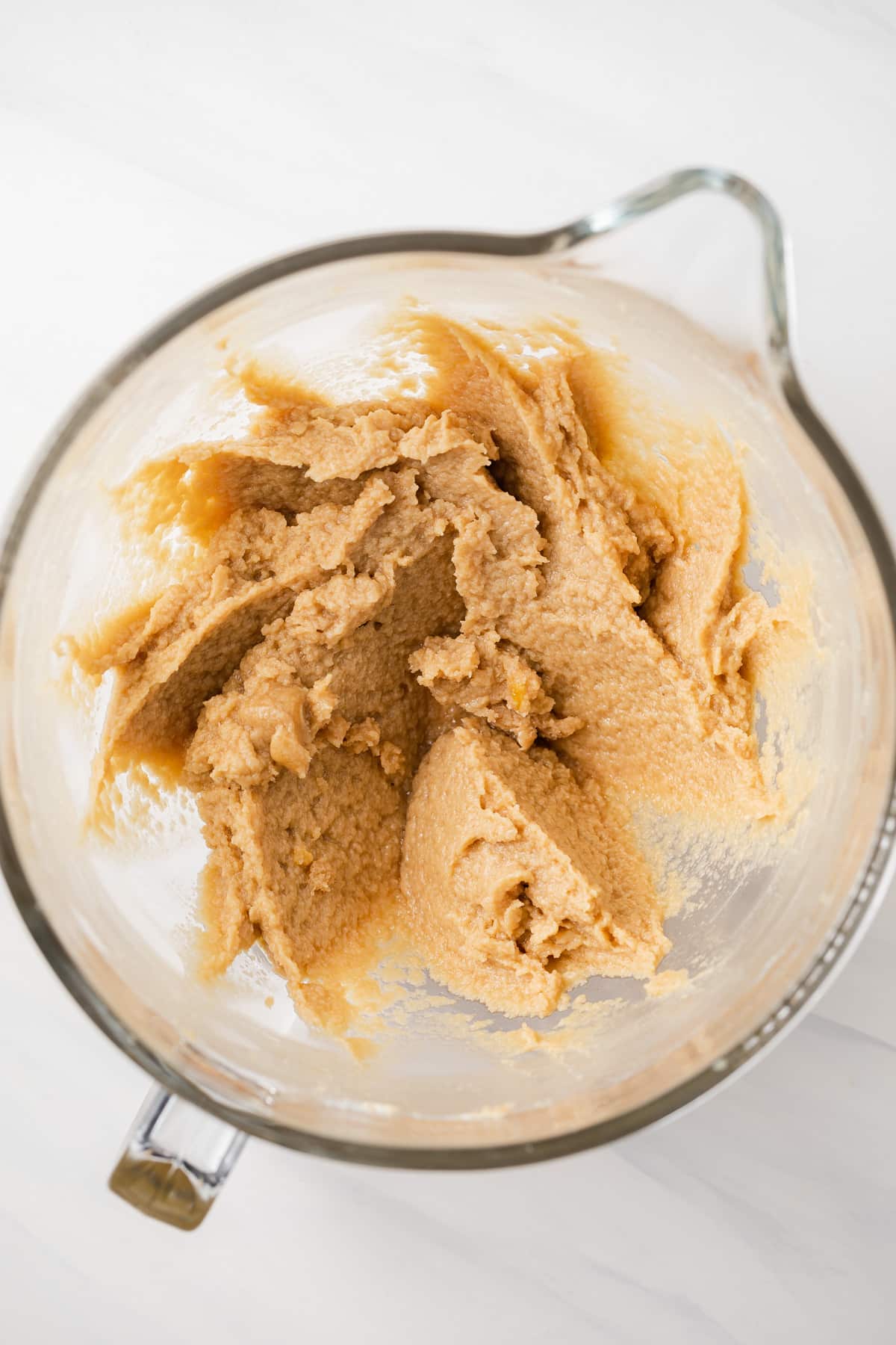 Creamed butter and sugar in glass bowl.