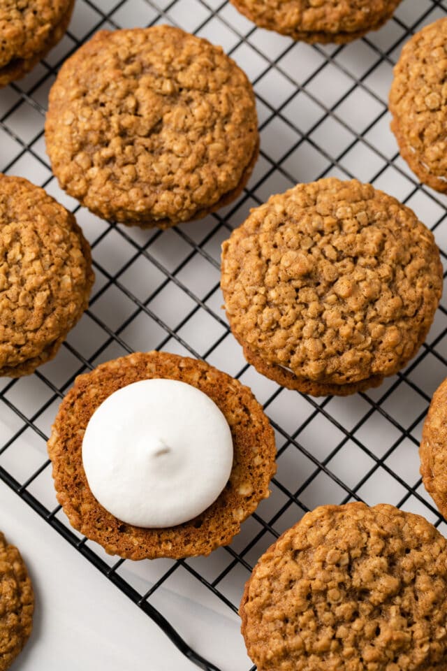 Cream filling piped over oatmeal cookies.