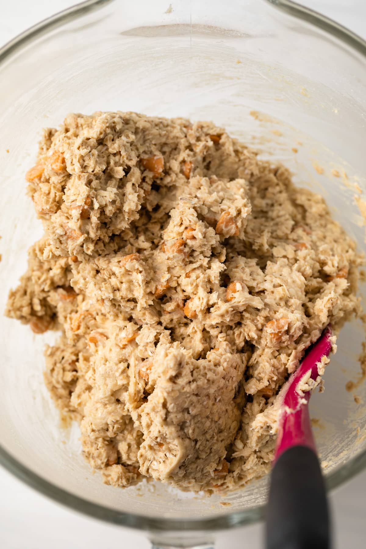 Oatmeal scotchie cookie dough in glass bowl.