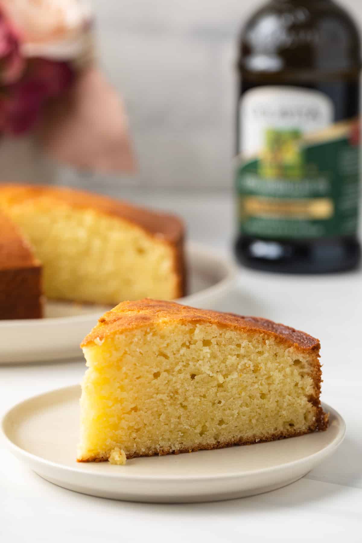Slice of olive oil cake on plate.