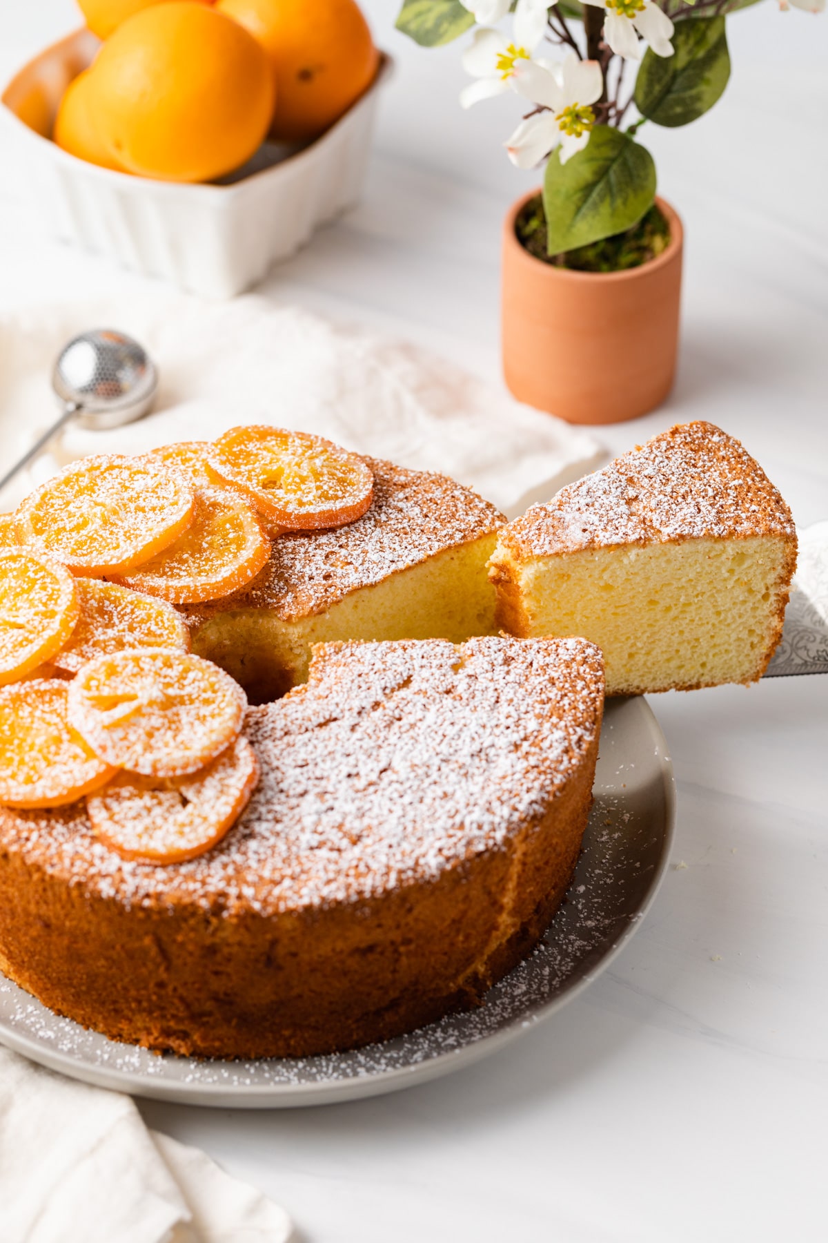 slice being taken out of orange chiffon cake