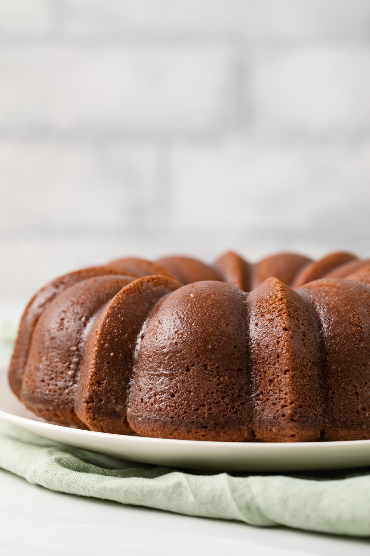 orange pound cake on plate with green napkin