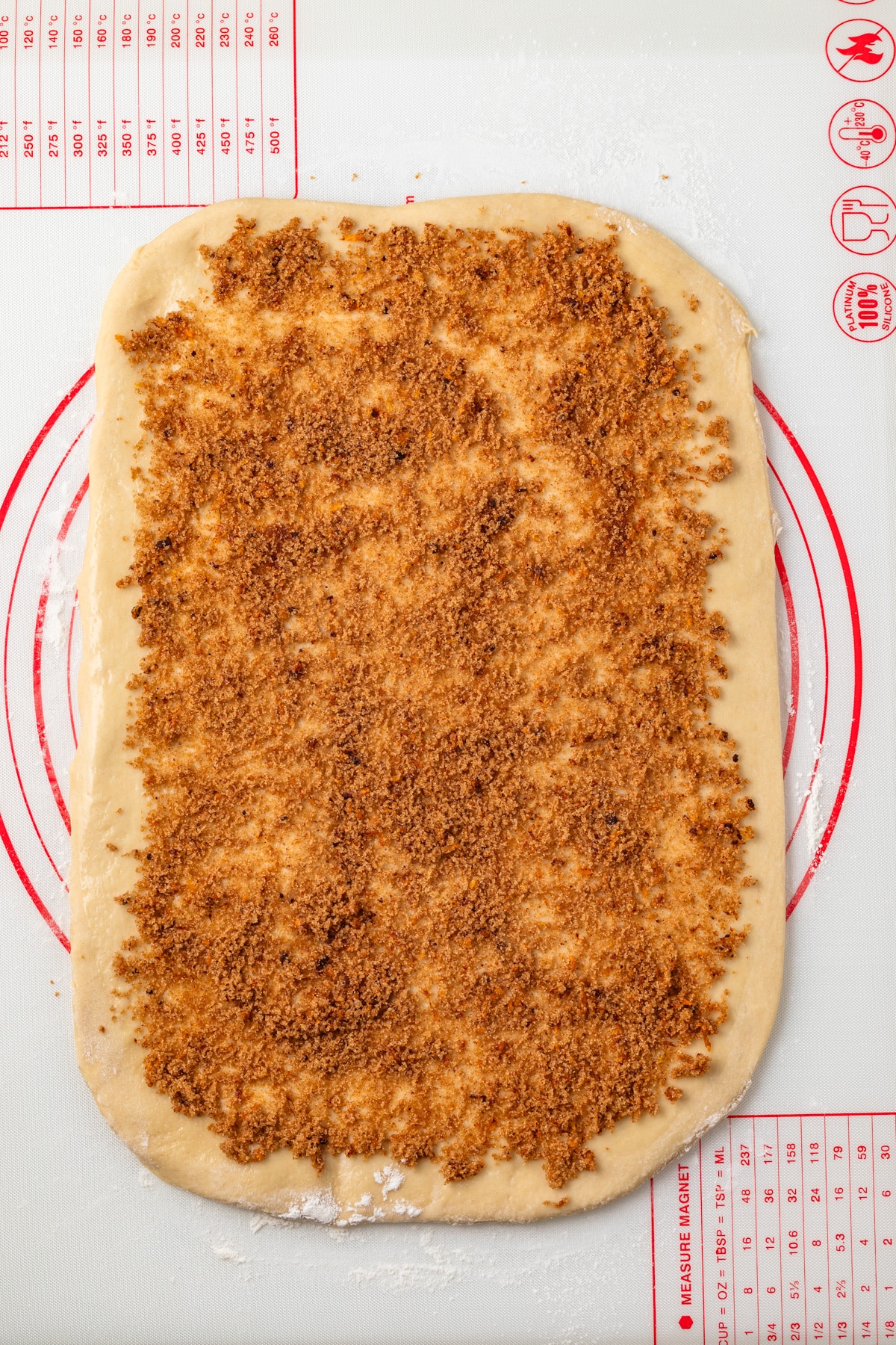 Cinnamon sugar filling spread over dough.