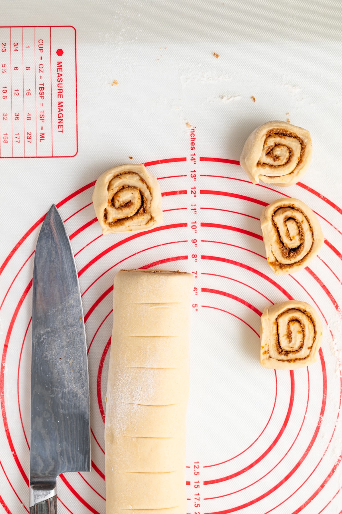 Sweet roll dough being sliced.