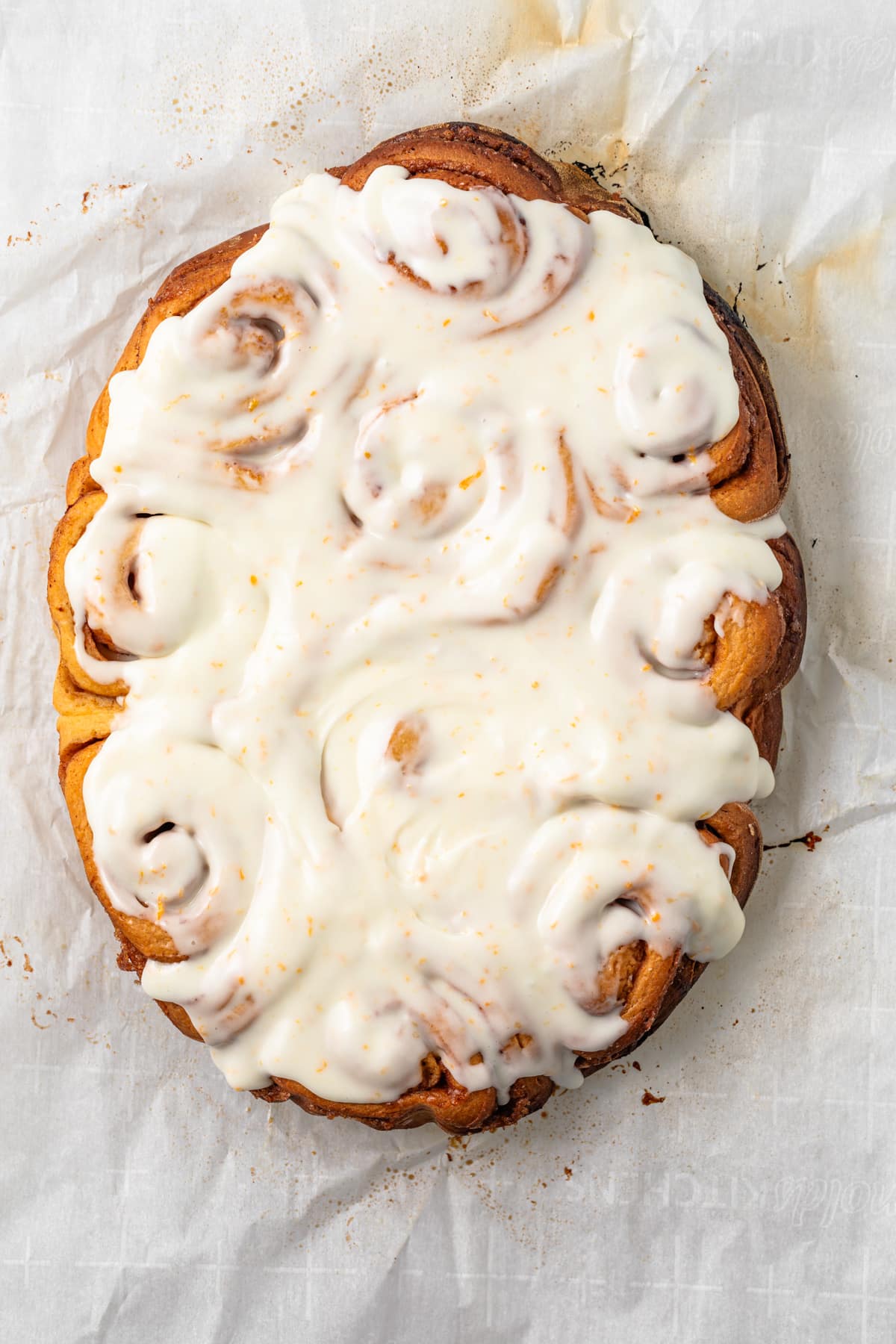 Overhead view of orange sweet rolls.