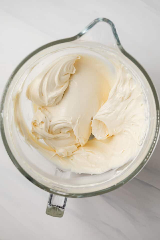 Cream cheese and sugar mixed in mixing bowl.