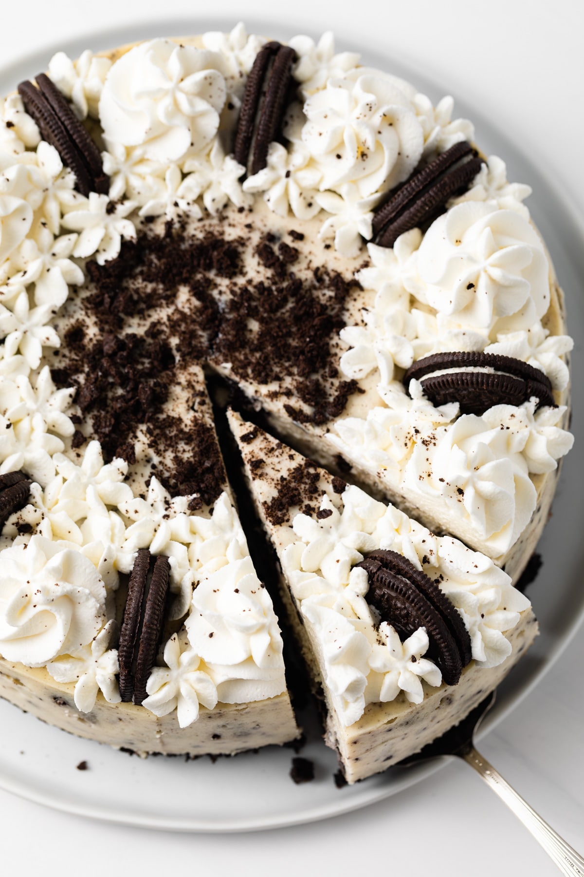 close up of oreo cheesecake with a slice being taken out