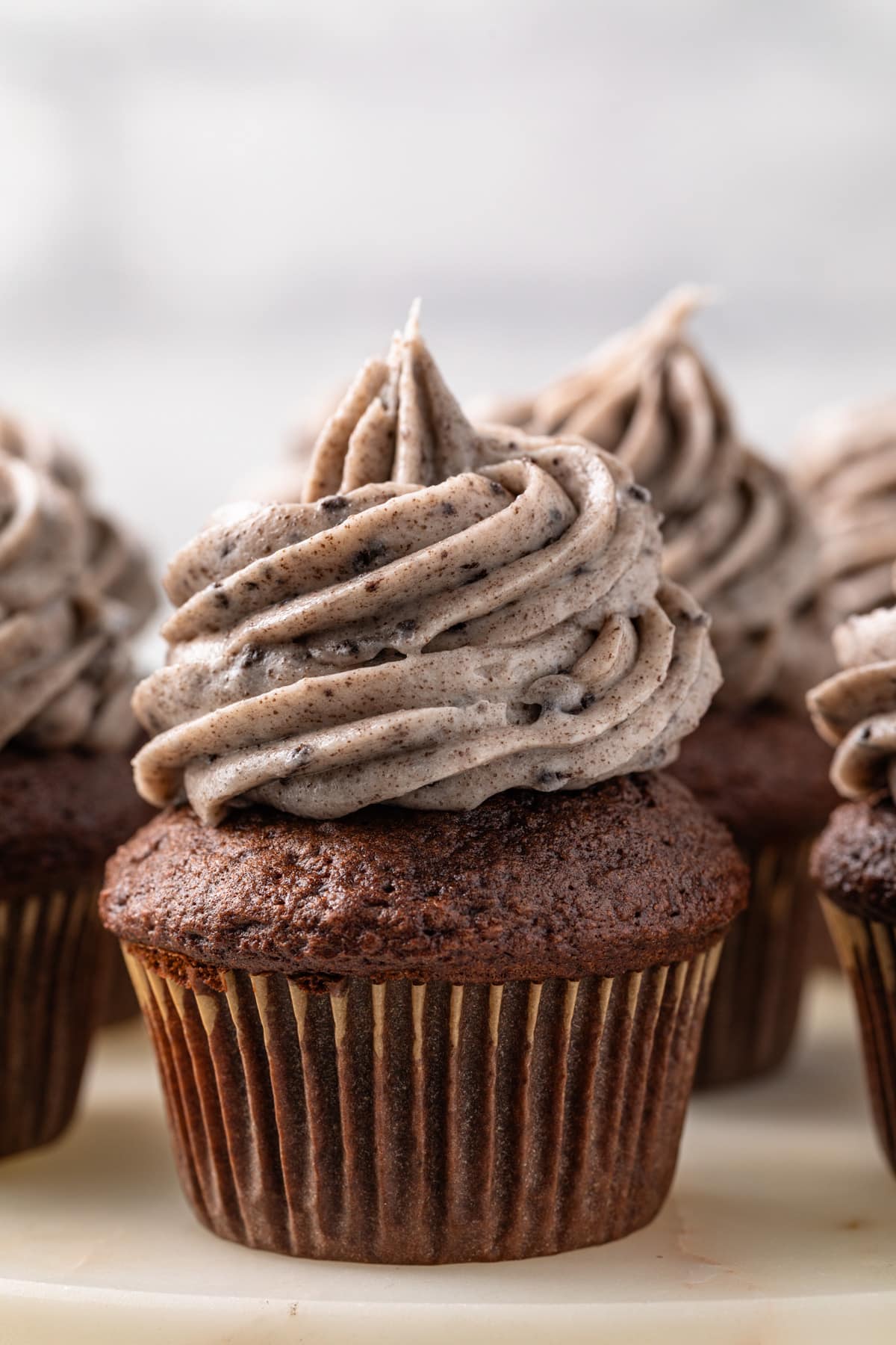 Chocolate cupcakes frosted with Oreo frosting.