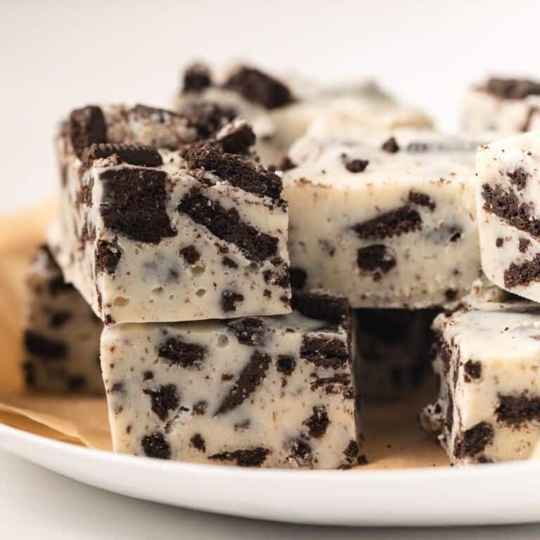 Oreo fudge stacked on white plate.