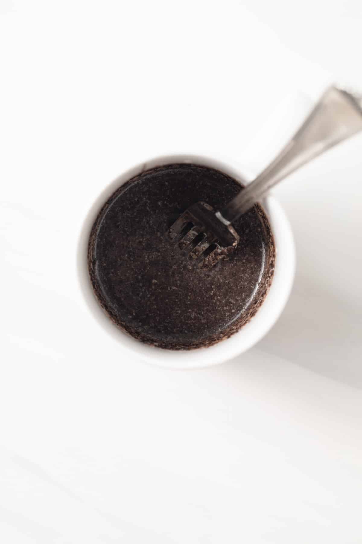 Crushed Oreos with milk in a mug.