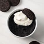 Overhead of Oreo mug cake topped with whipped cream.