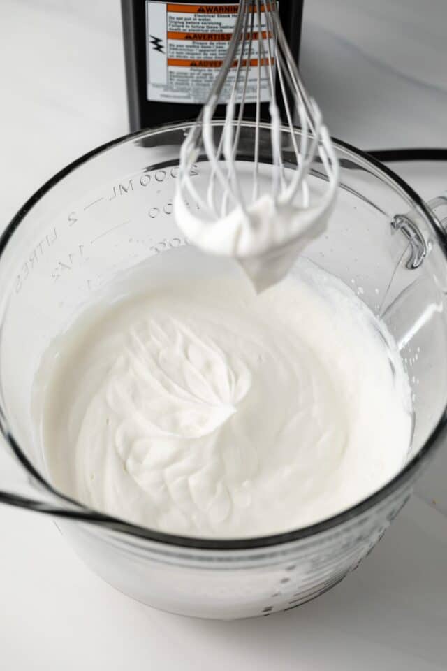 Whipped cream in glass bowl.