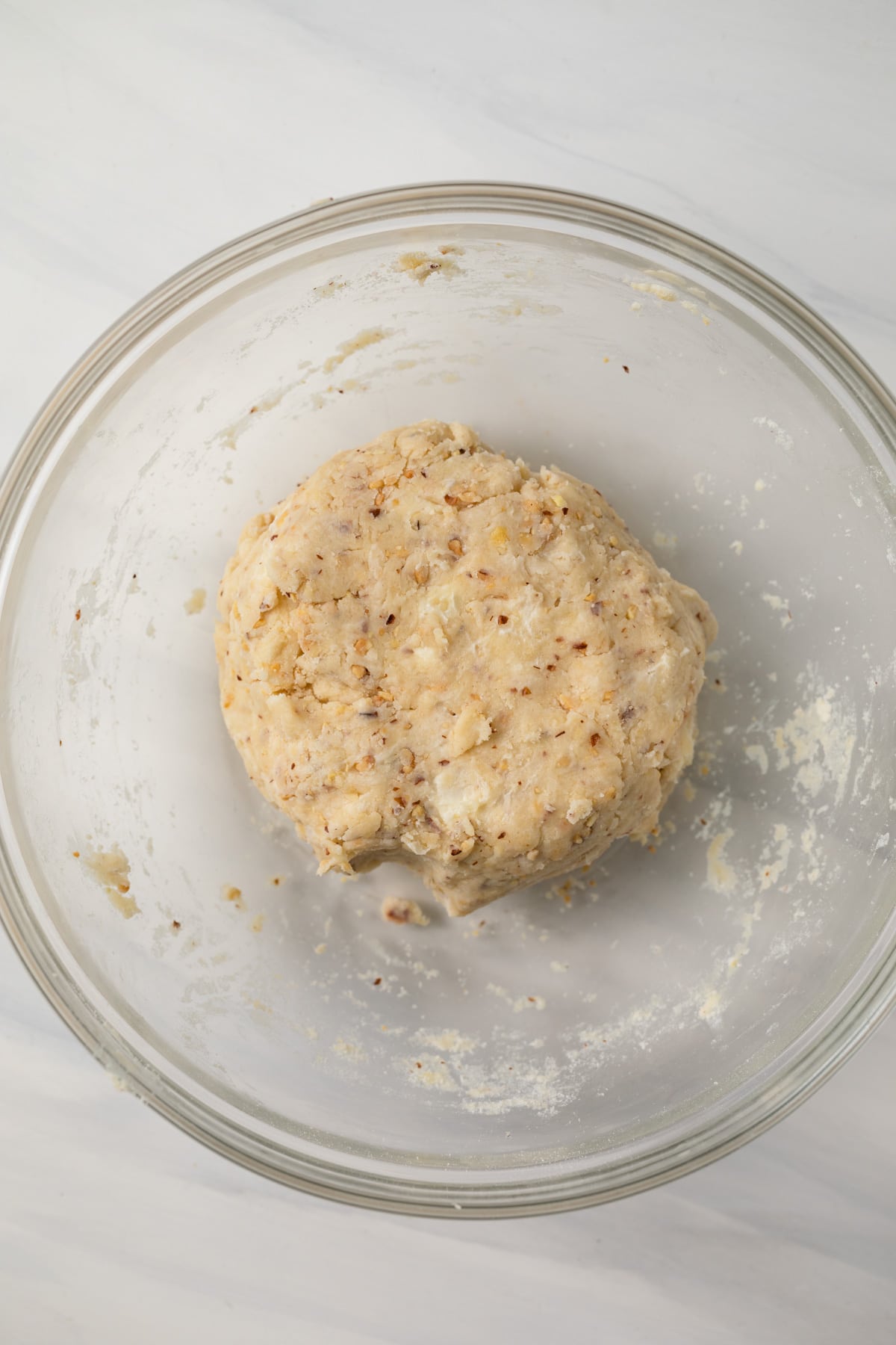 Almond pastry dough in glass bowl.