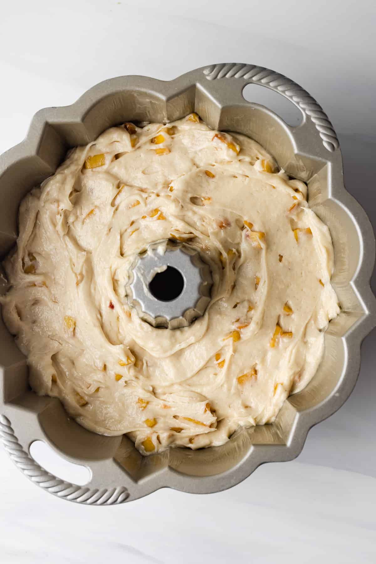 Peach pound cake in a pan ready to be baked