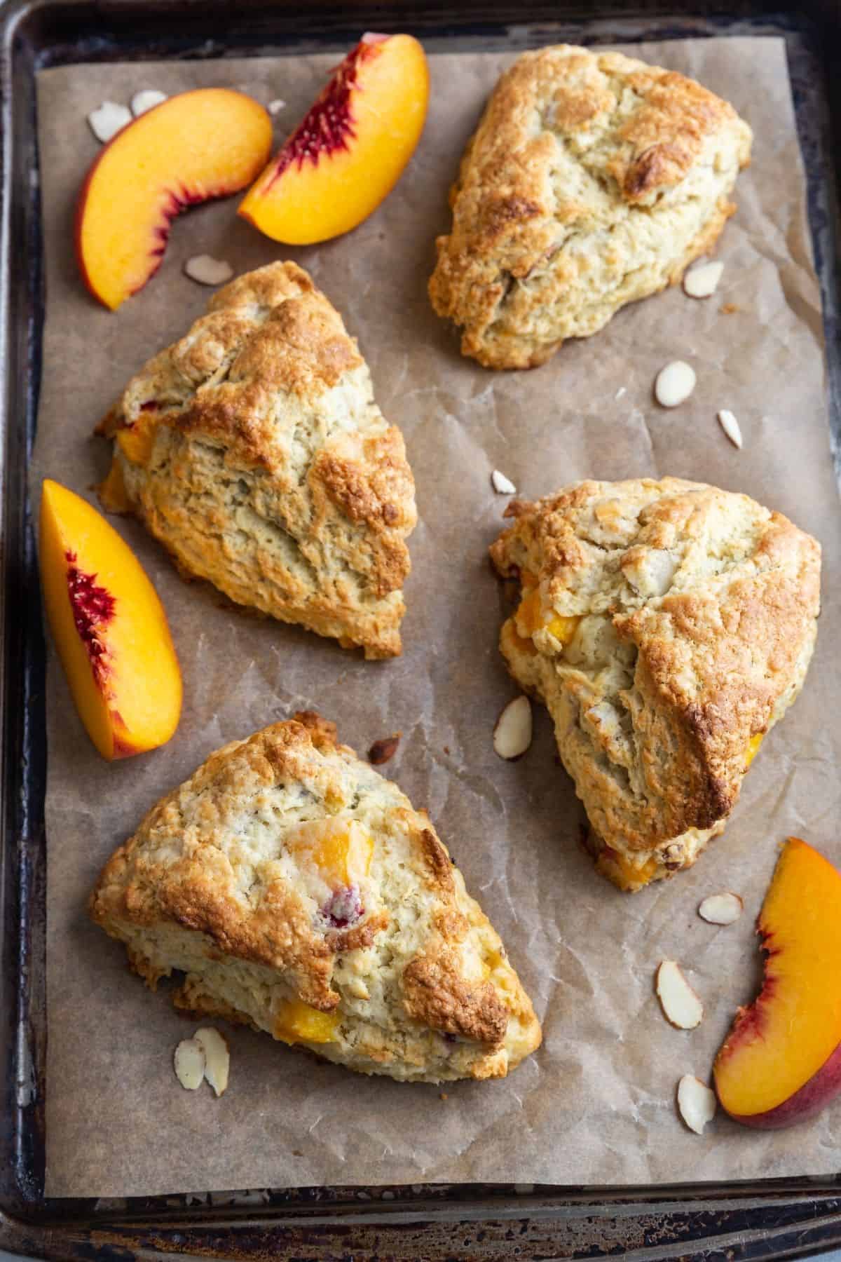 Overhead view of peach scones on a baking sheet.