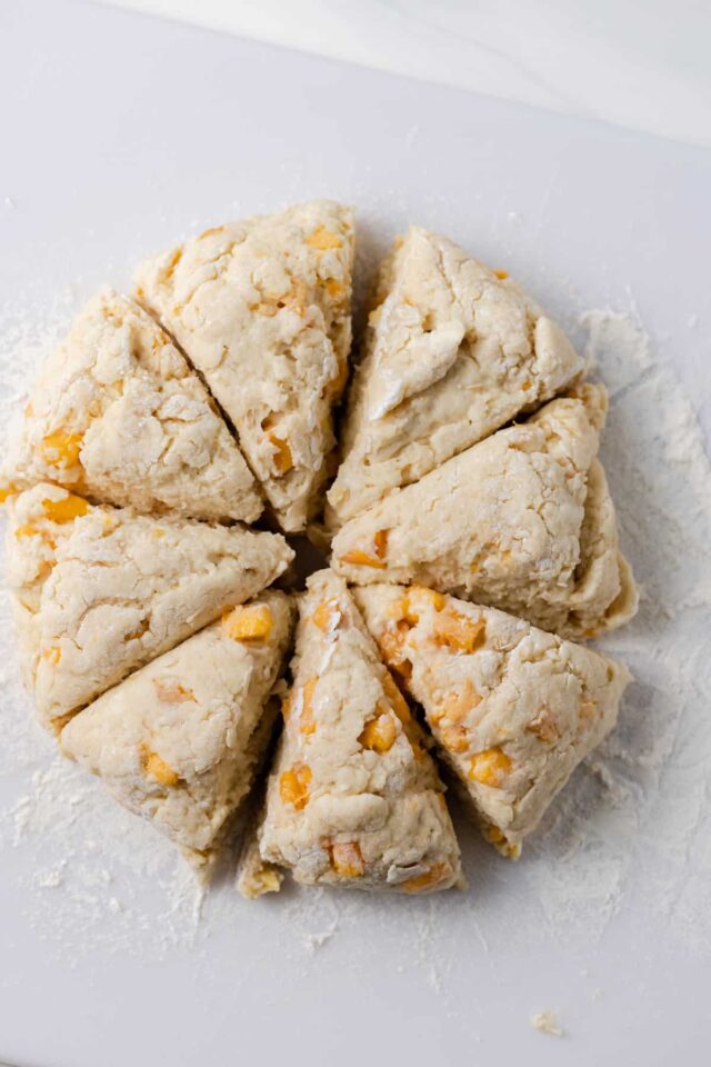 Peach almond scone dough cut into 8 pieces