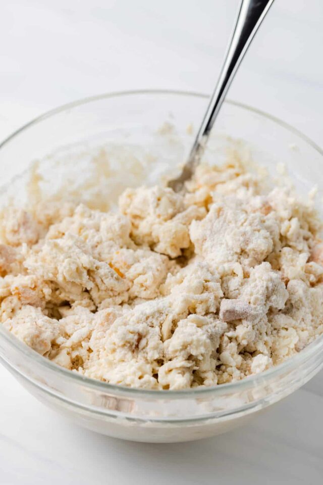 Peach scone batter in a white baking dish
