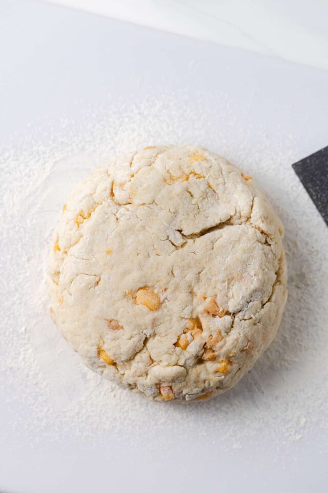 A disc of peach almond scone batter