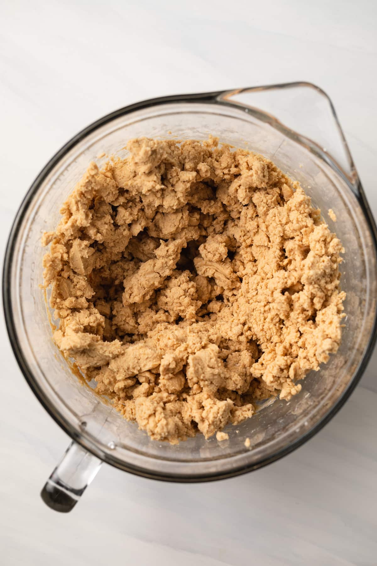 Peanut butter ball dough in glass bowl.