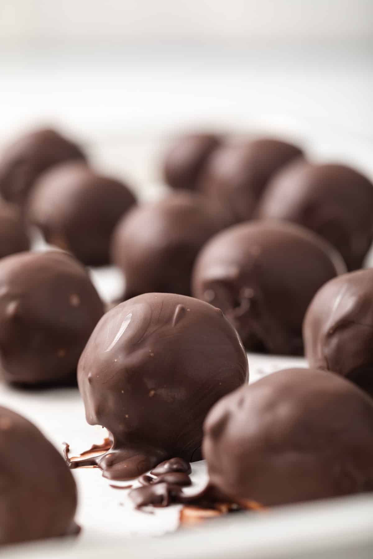 Side view of peanut butter balls on baking sheet.