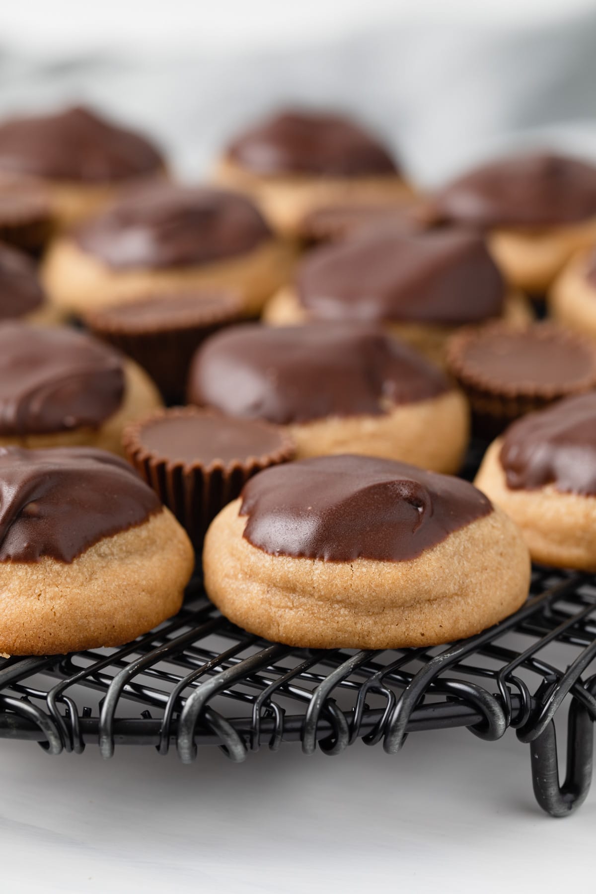 Side view of peanut butter cup cookies on wire rack.