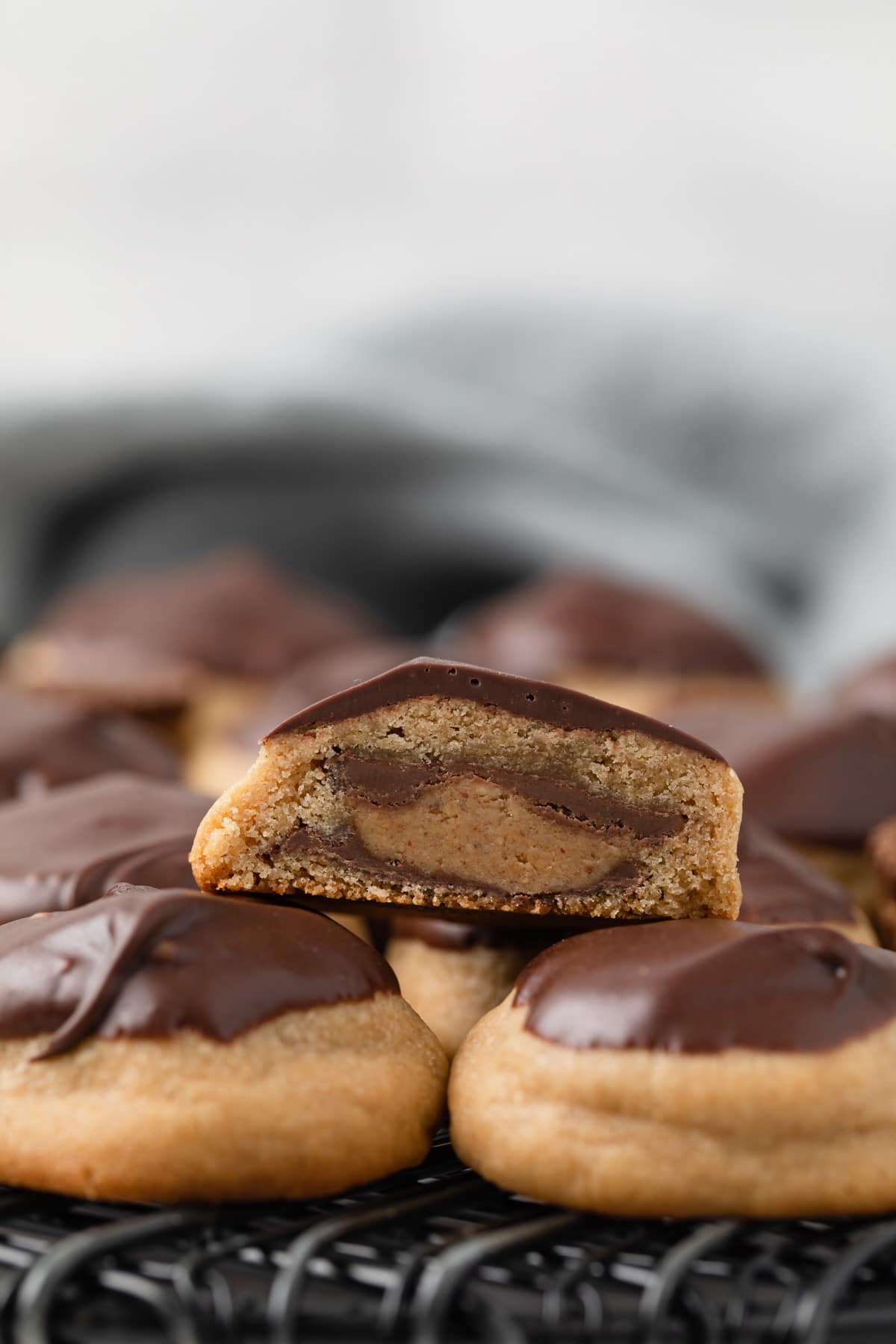 Side view of peanut butter cup cookies with one slice open so the inside is visible.