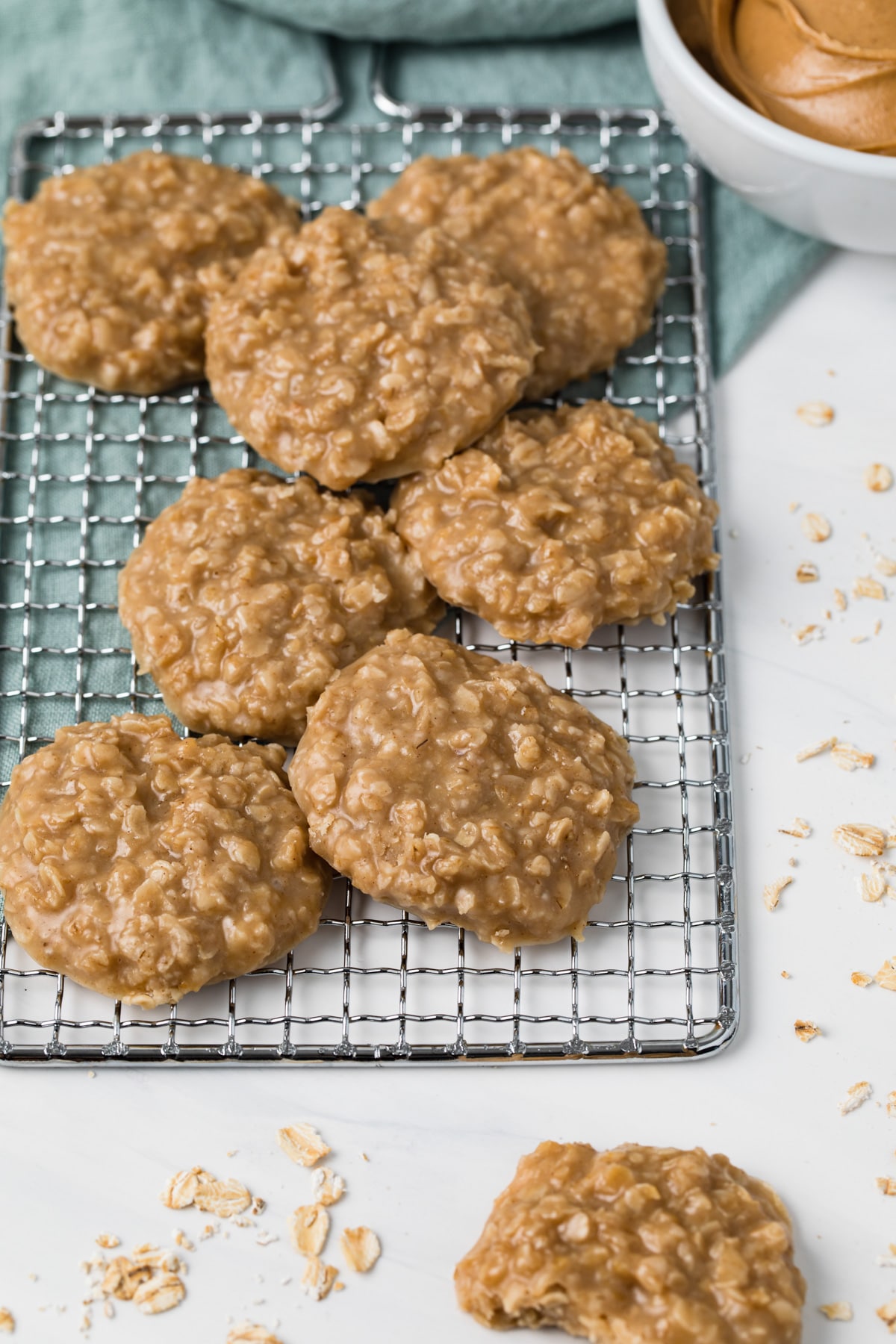 angled view of peanut butter no bake cookies scattered on wire rack