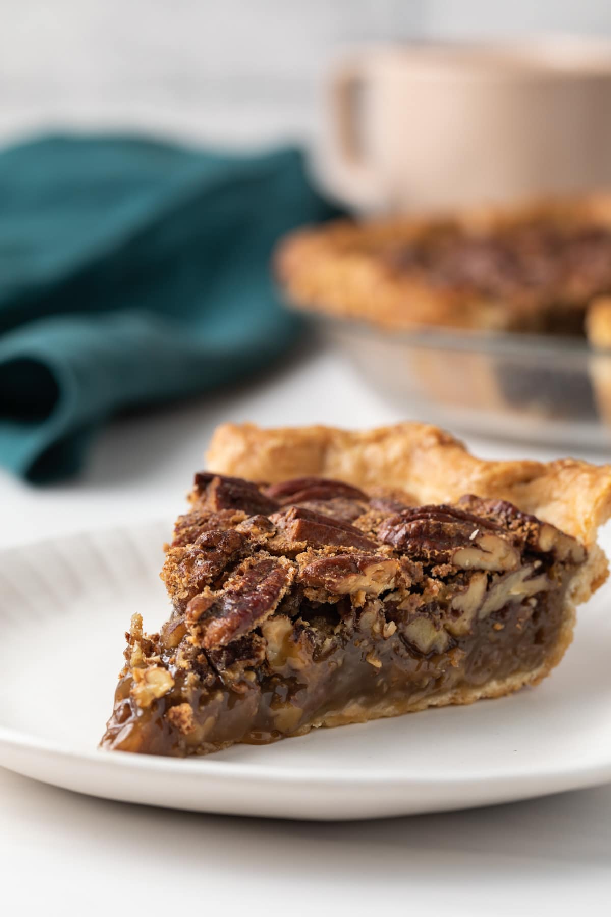 close up of pecan pie slice on white plate