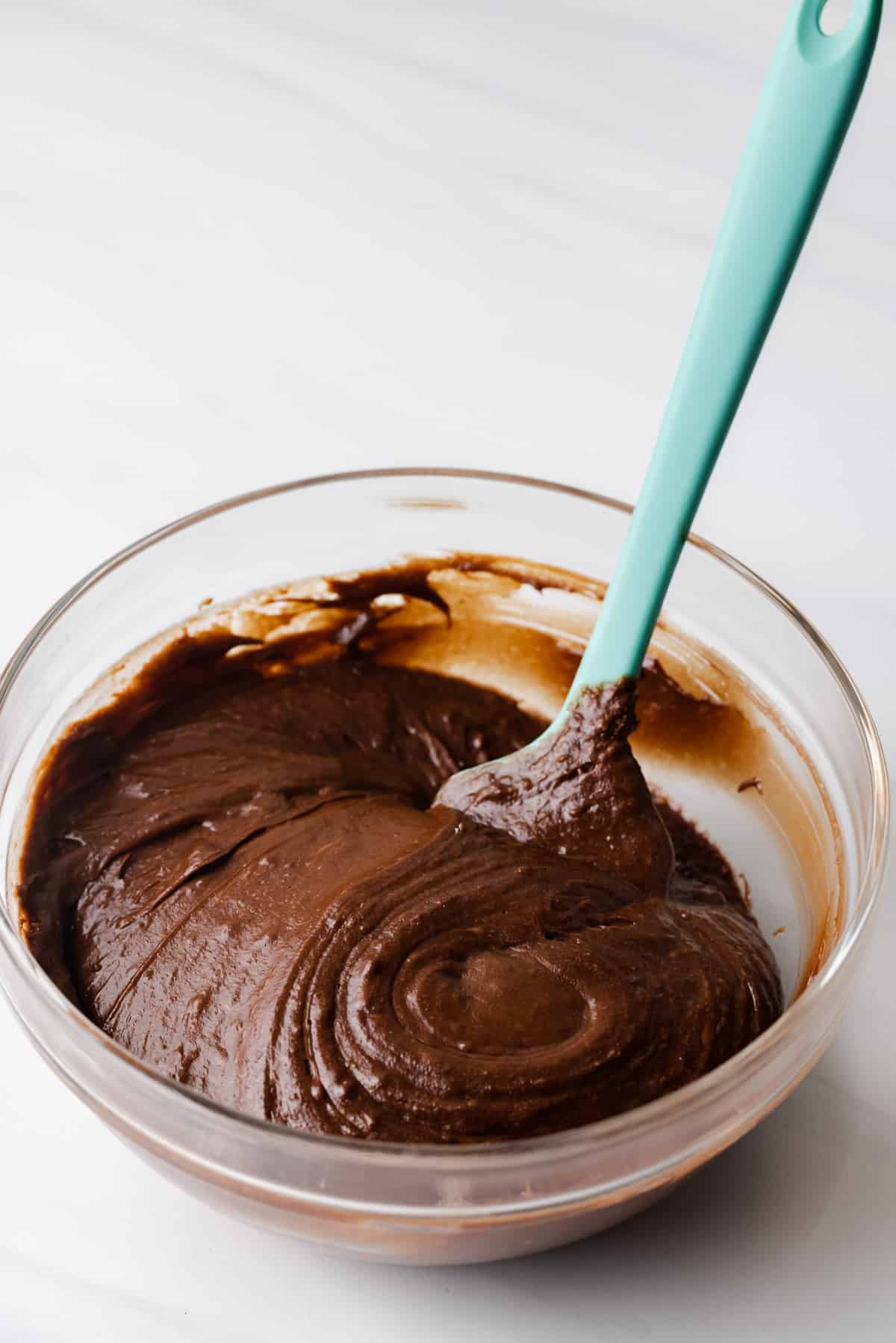 A spatula stirring melted chocolate