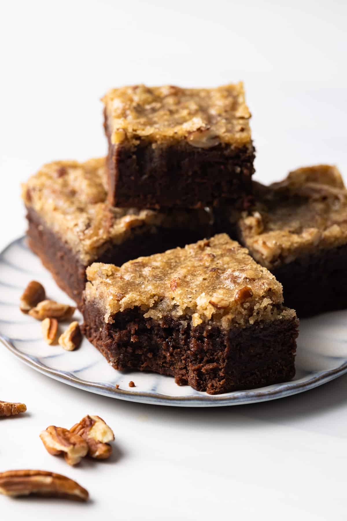 Four pecan pie brownies on a plate