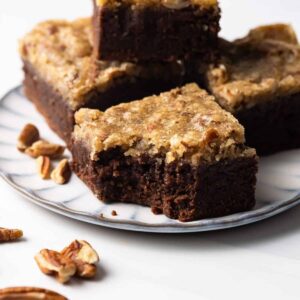 Four pecan pie brownies on a plate