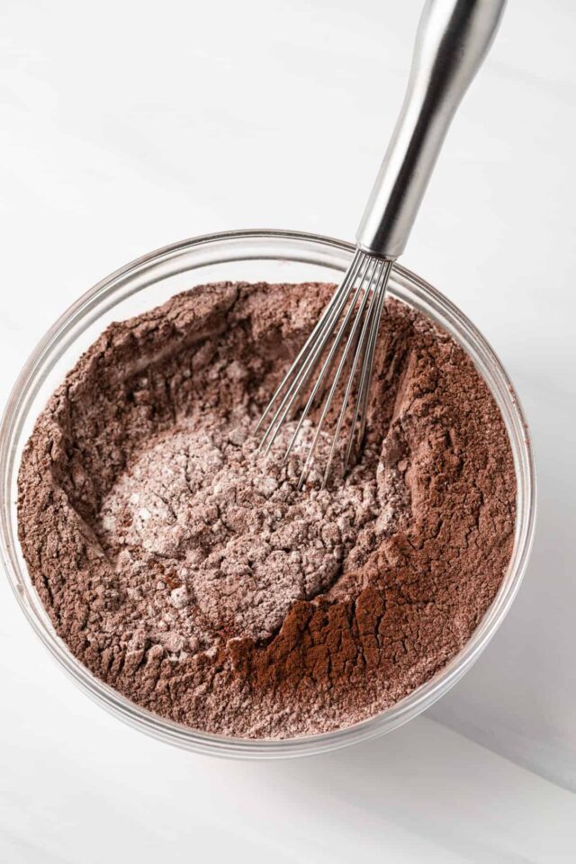 A whisk mixing dry cake ingredients