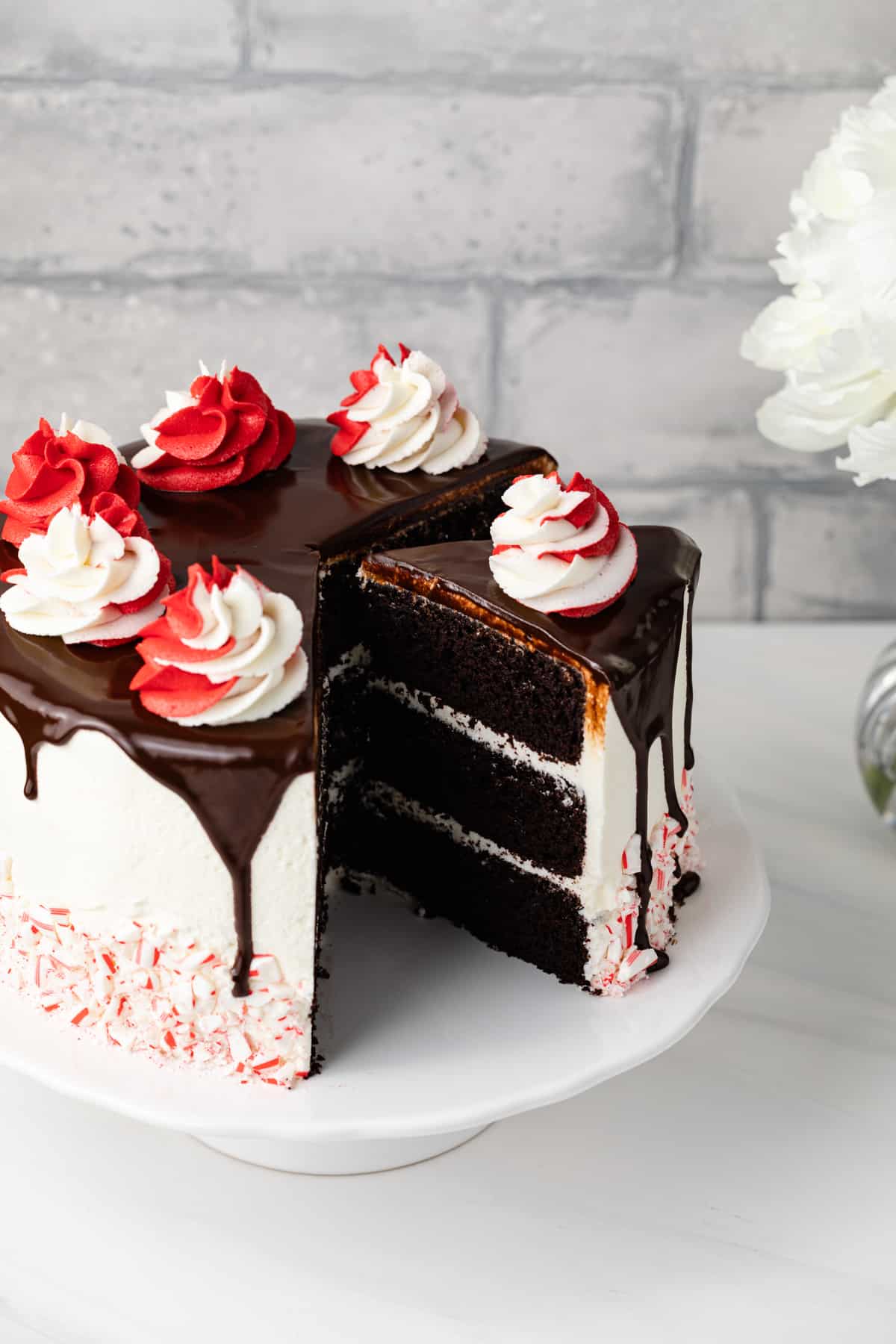 A peppermint fudge cake with a slice pulled away