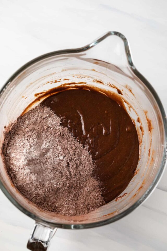 Dry and wet cake batter ingredients being added together