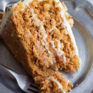 carrot cake with pineapple on a pewter plate with fork