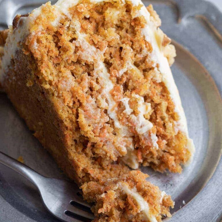 carrot cake with pineapple on a pewter plate with fork