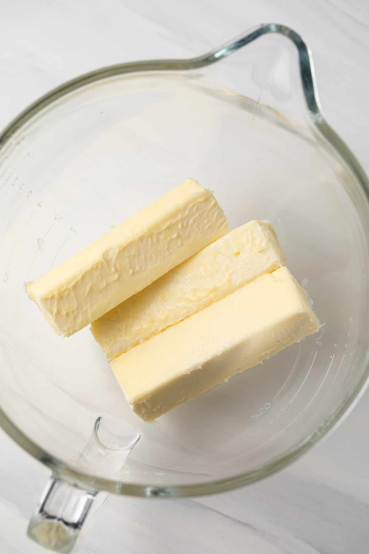 Softened butter in a glass bowl.