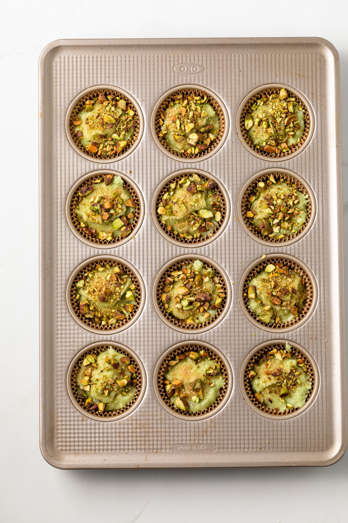 Unbaked muffins in a muffin tin.
