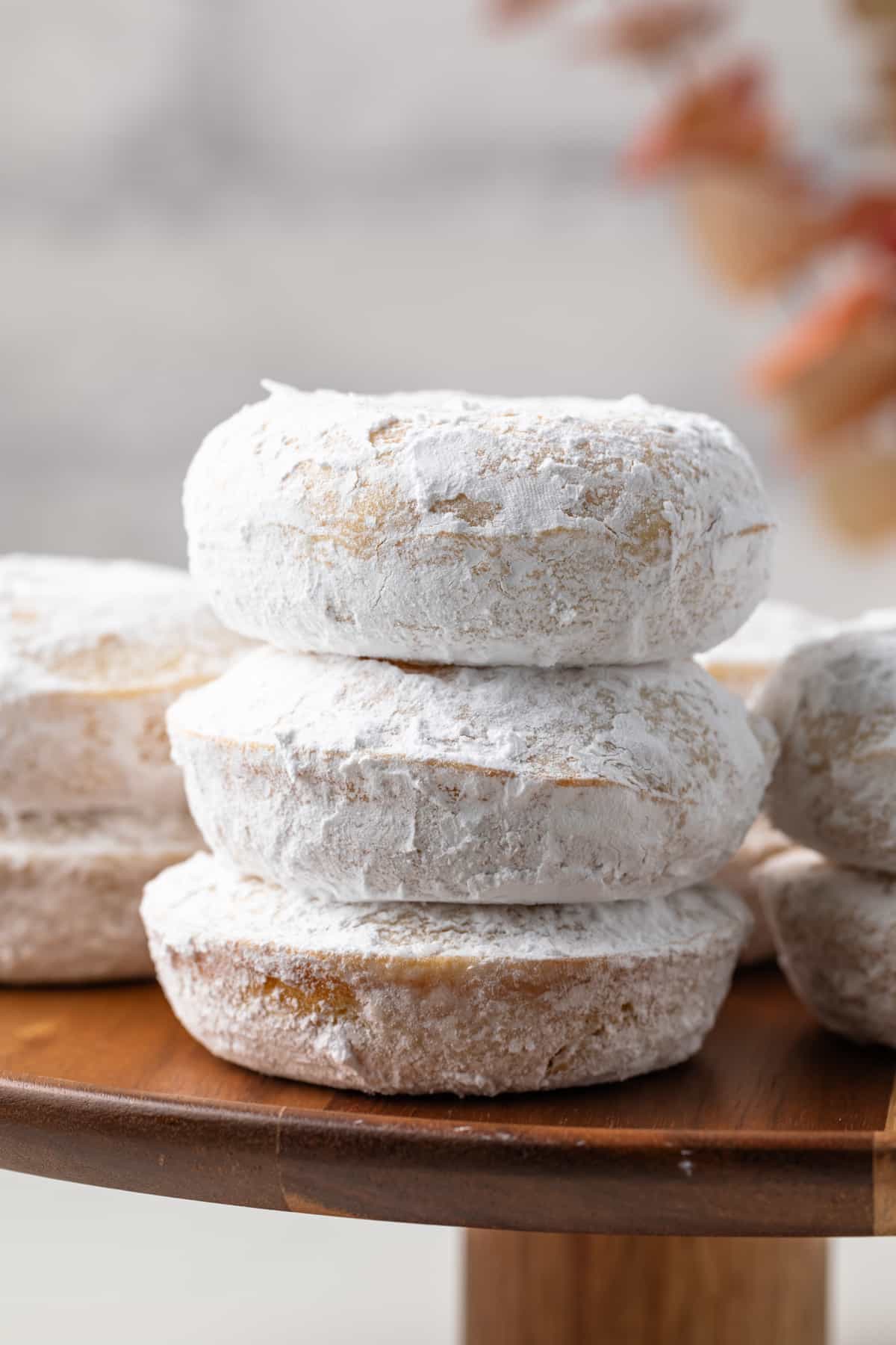 Stack of powdered sugar donuts.
