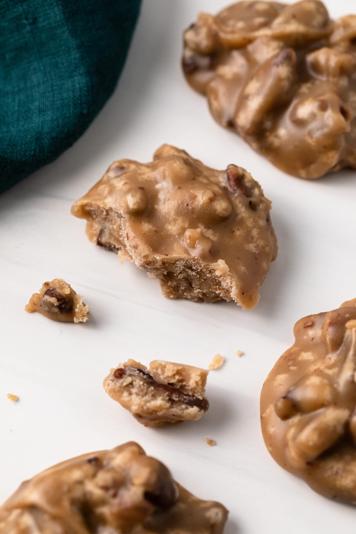 praline pecans with small pieces broken off of one