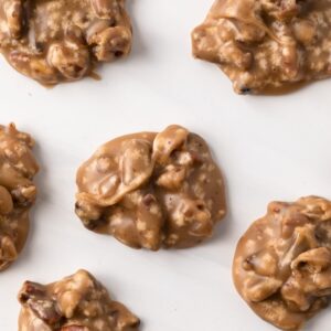 overhead of praline pecans neatly arranged on white background