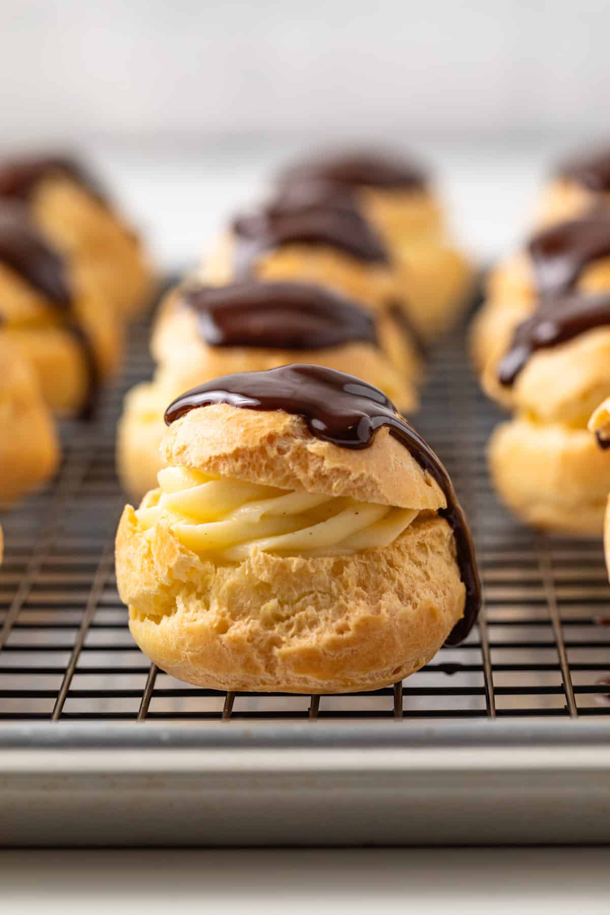 Profiteroles on a wire rack.